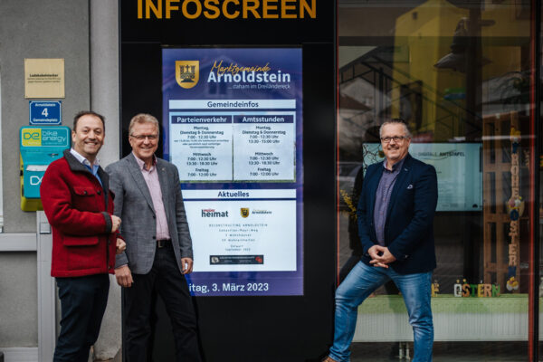 Bürgermeister Reinhard Antolitsch, Amtsleiter Gernot Obermoser und Geschäftsführer monitorwerbung Kärnten Andreas Lanner vor dem Semi-Outdoor Monitor von Wallerie in Arnoldstein