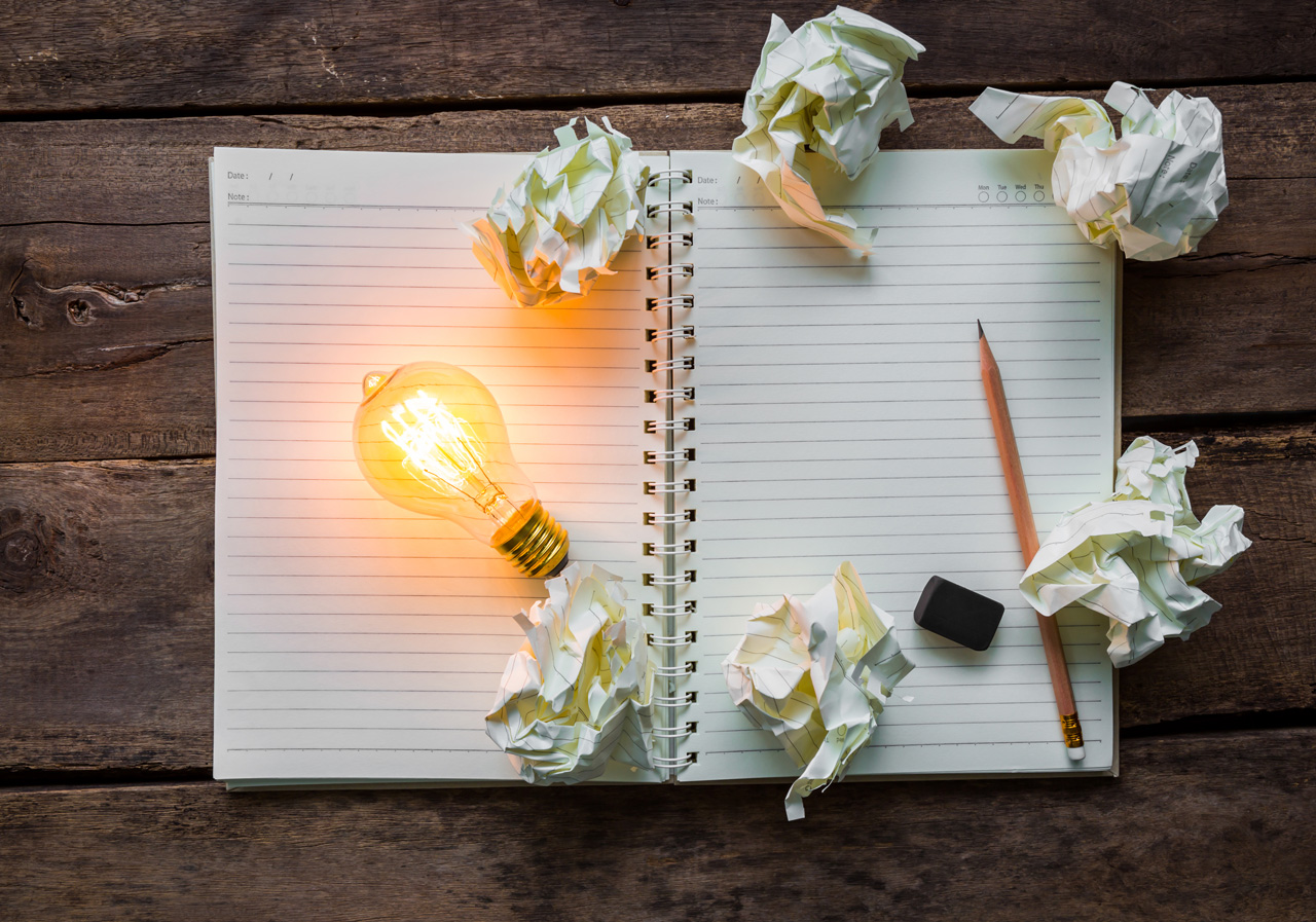 top-view-lit-light-bulb-paper-balls-web